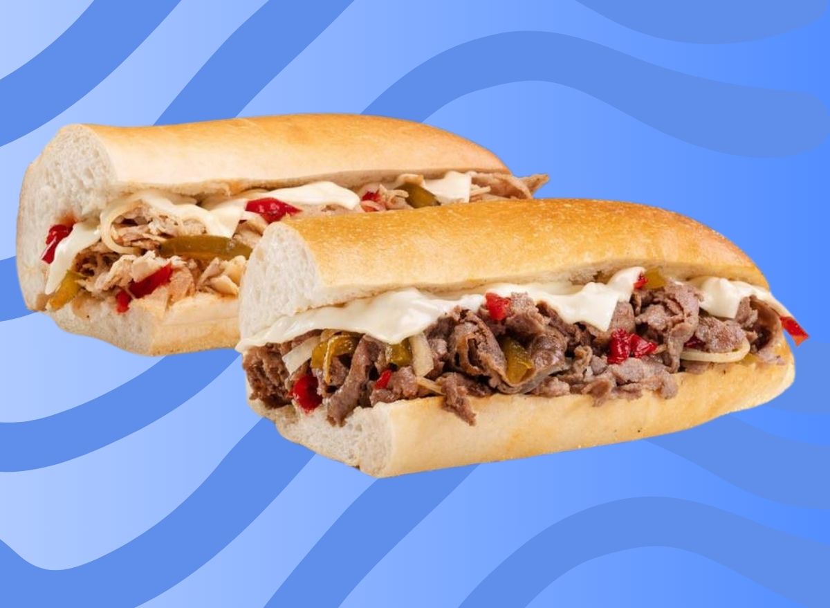 A pair of cheesesteak subs from Jersey Mike's, set against a swirly blue background