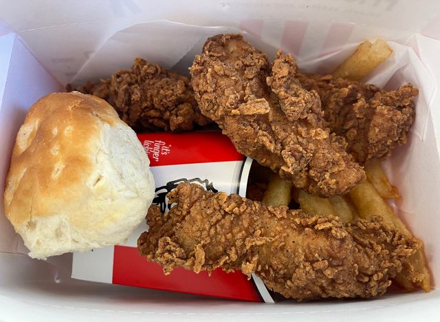 A box of KFC's new Original Recipe Chicken Tenders with fries and a biscuit