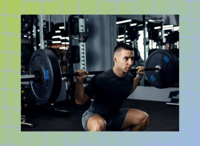 man doing a barbell back squat at the gym