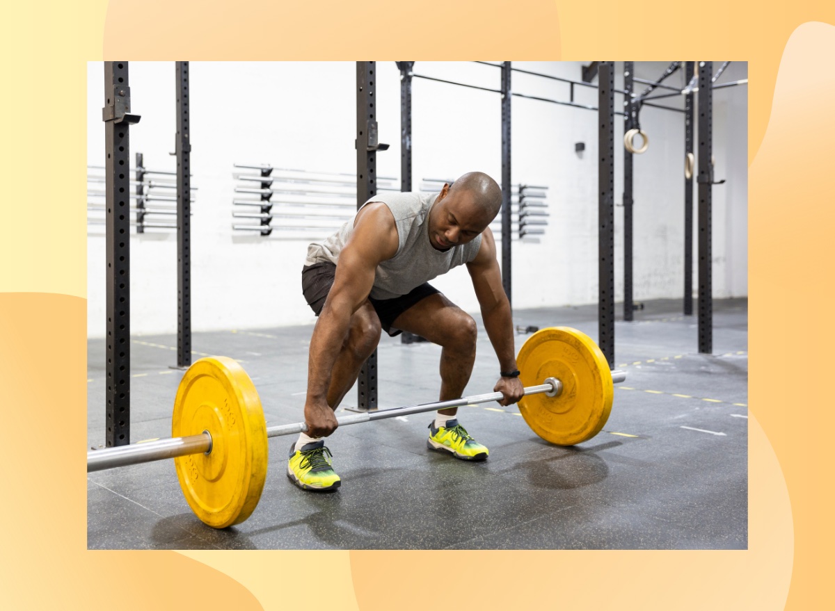 fit man doing a barbell deadlift at the gym