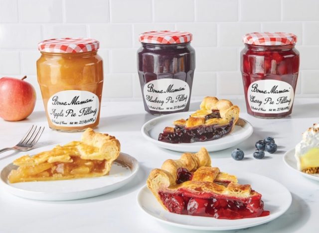 Bonne Maman's apple, blueberry, and cherry pie fillings behind plates of pies