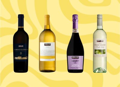 Four bottles of Costco Kirkland wine on a graphic yellow background.