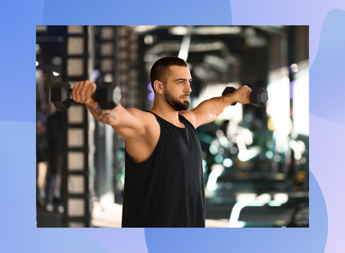 fit, muscular man doing dumbbell lateral raise exercise at the gym