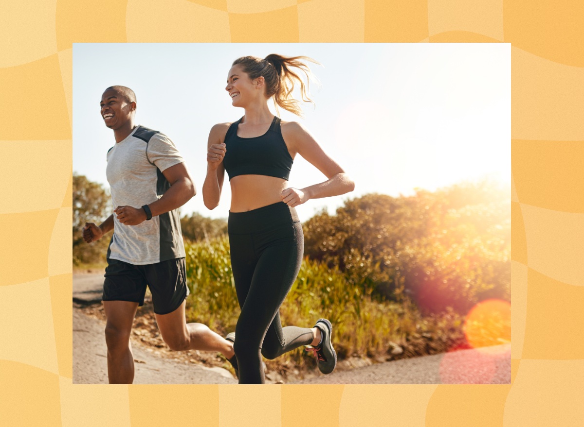 fit, happy couple running outdoors through trails on a sunny day