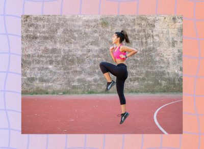 woman doing high knees exercise outdoors on track