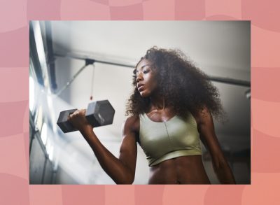 fit woman lifting dumbbells at the gym