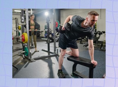 fitness man doing dumbbell row at the gym