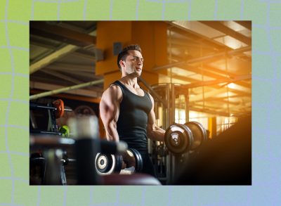 fit, muscular man lifting dumbbells at the gym