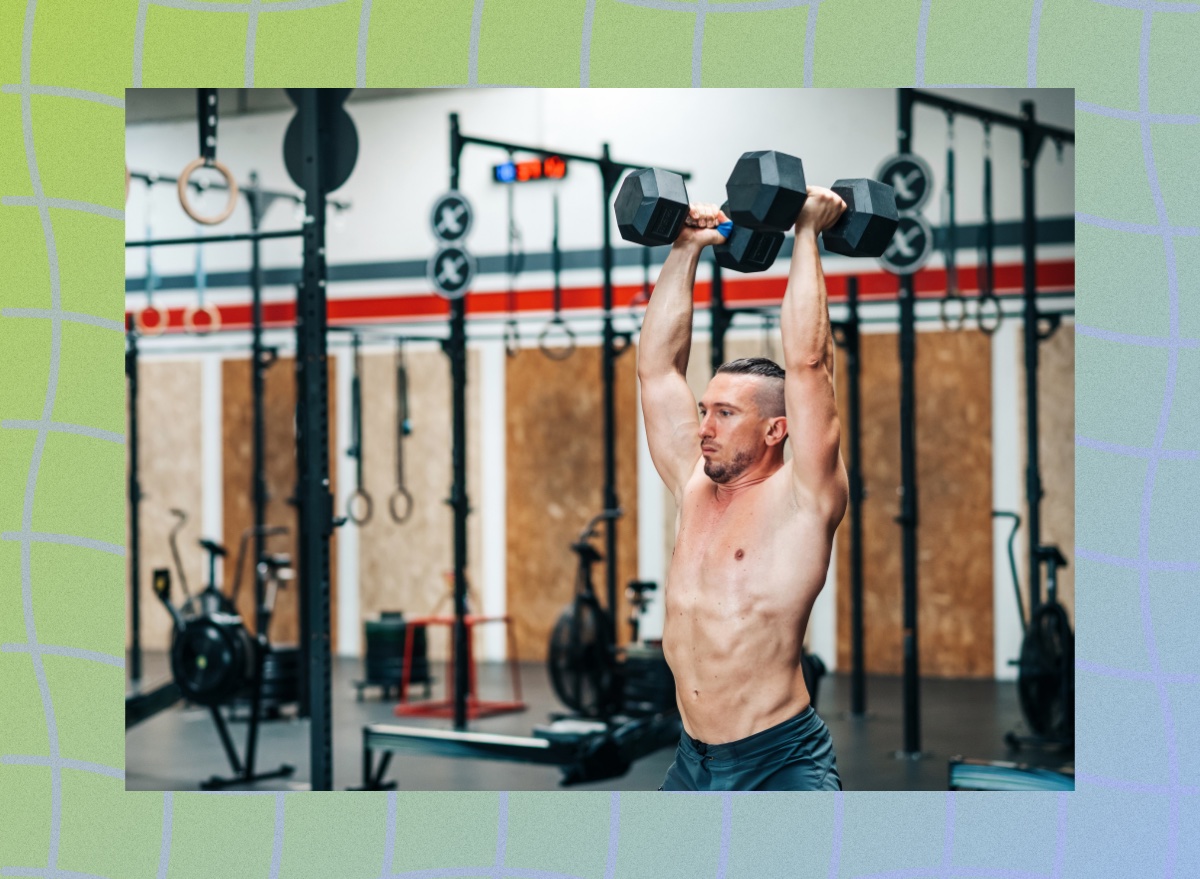 fit, muscular man pressing dumbbells overhead