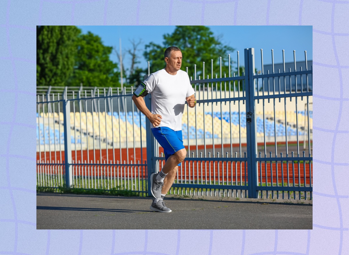 mature man running outdoors for exercise near a school track