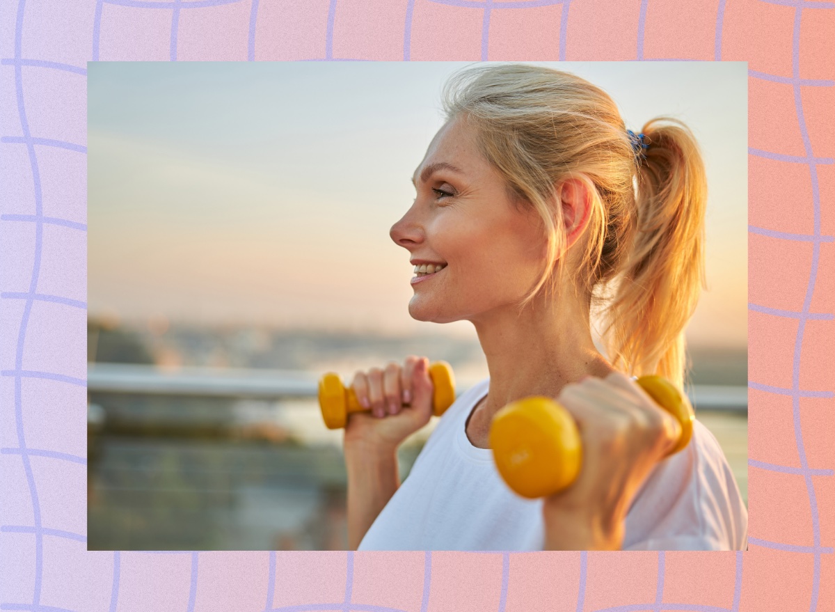 close-up of mature blonde woman walking while lifting dumbbells at sunset