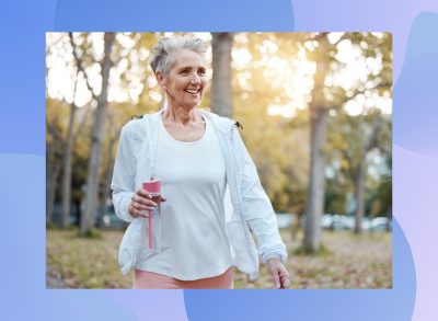 mature, happy woman walking outdoors in the park on fall day