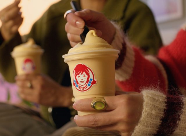 people holding Wendy's Salted Caramel Frosty