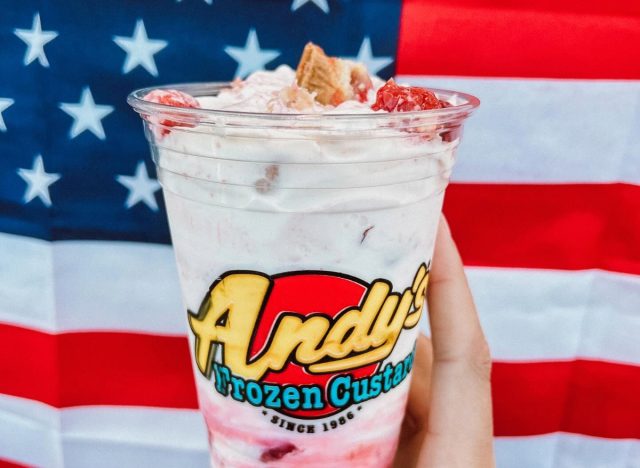 person holding Andy's Frozen Custard's Cherry Pie Concrete in front of an American Flag