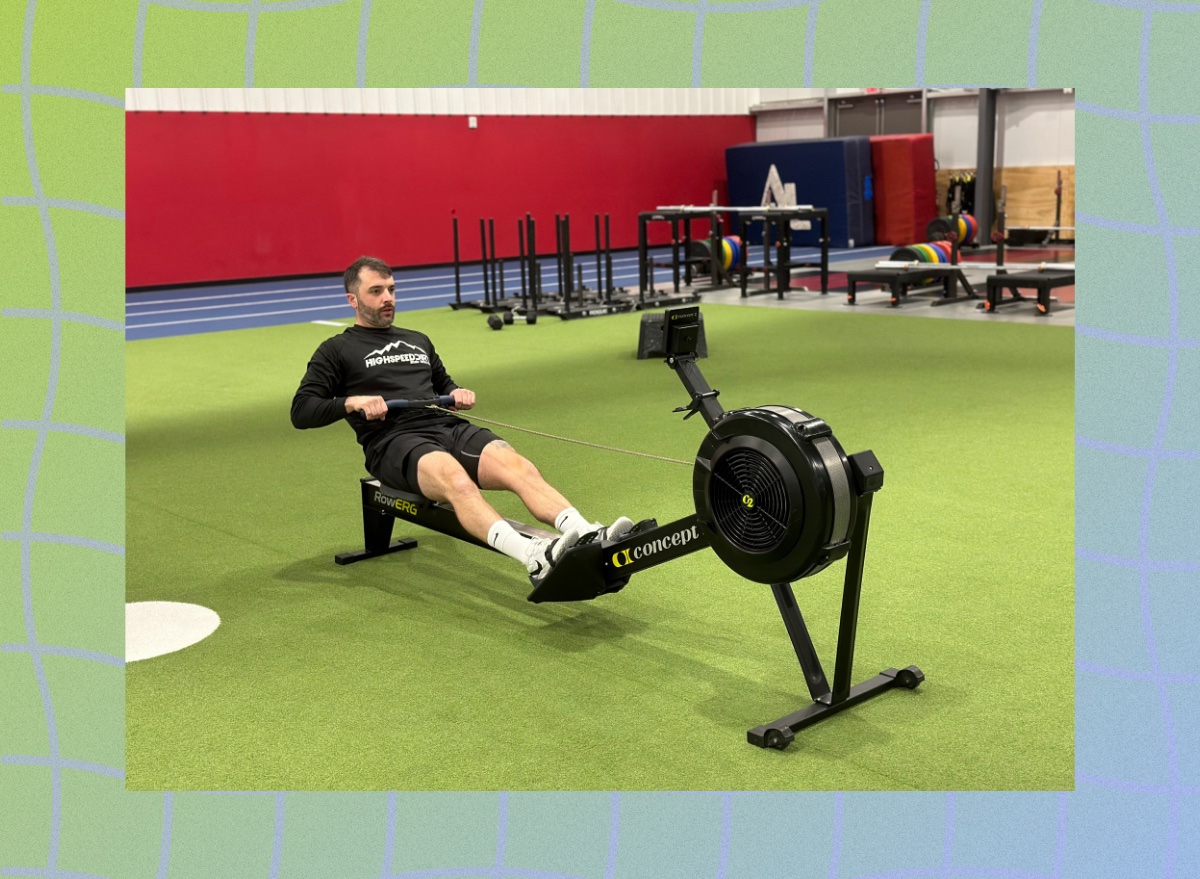 personal trainer doing a rowing workout at the gym