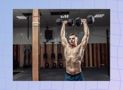 fit, muscular man doing a dumbbell shoulder press exercise at the gym