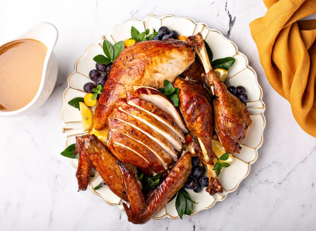 Carved roasted turkey for the celebration Thanksgiving or Christmas dinner on a plate overhead shot