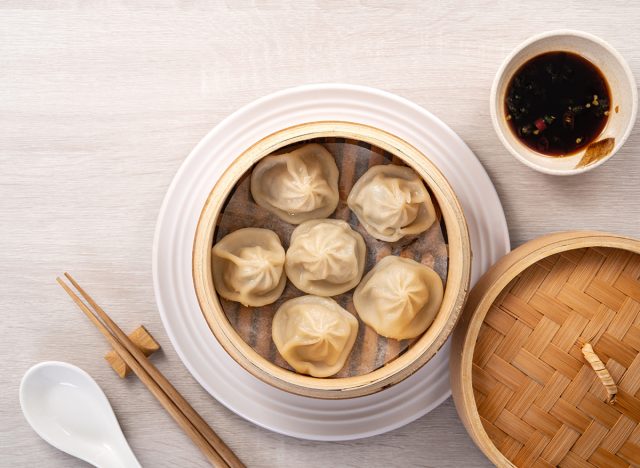 Eating steamed pork soup dumplings named Xiao long bao xiaolongbao in Taiwan, Taiwanese famous gourmet.