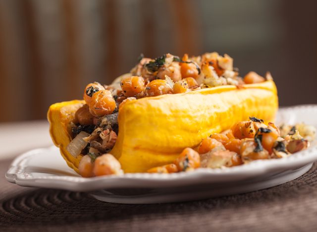 Side view of Delicata squash stuffed with garbanzo beans, kale, and onion