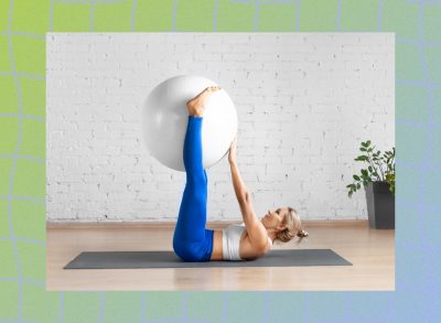 fit blonde woman doing stability ball ab exercise on workout mat in bright living space