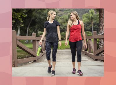 two blonde friends walking for exercise in park