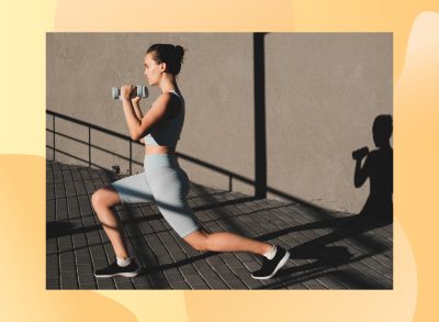 woman doing dumbbell walking lunges outdoors