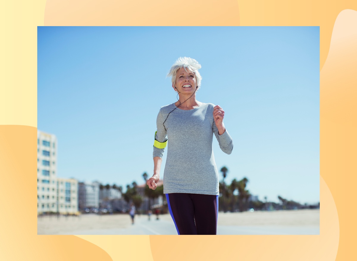 fit, mature woman power walking or jogging on the beach on a sunny day