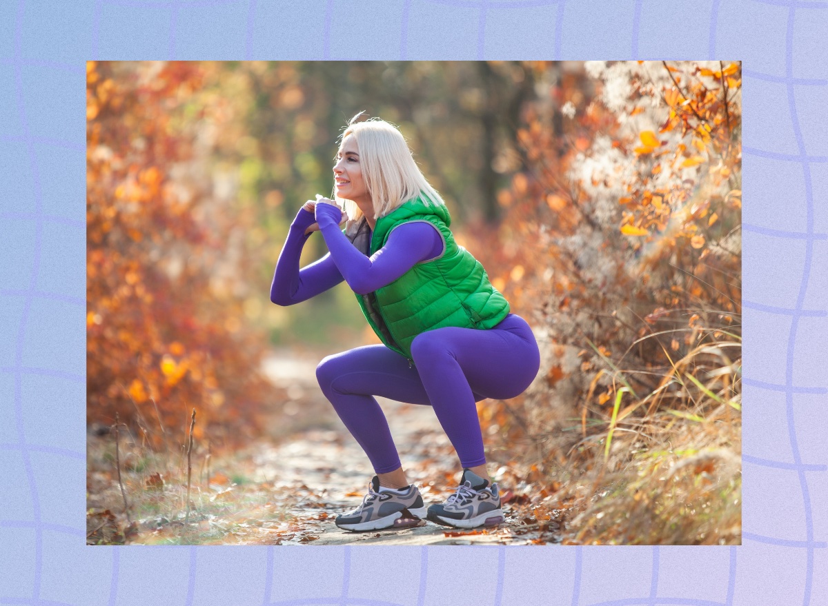 fit blonde woman doing squat exercise outdoors