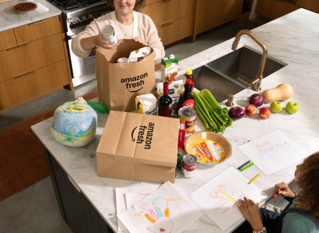 woman unpacking Amazon Fresh Thanksgiving ingredients