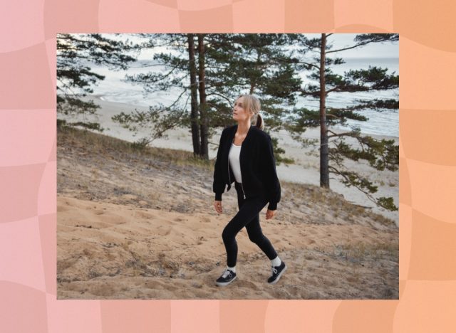 blonde woman walking uphill at the beach