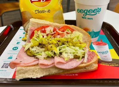 Eegee's sandwich, chips, and drink on a tray in restaurant