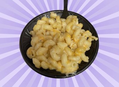 A container of mac and cheese set against a vibrant background.