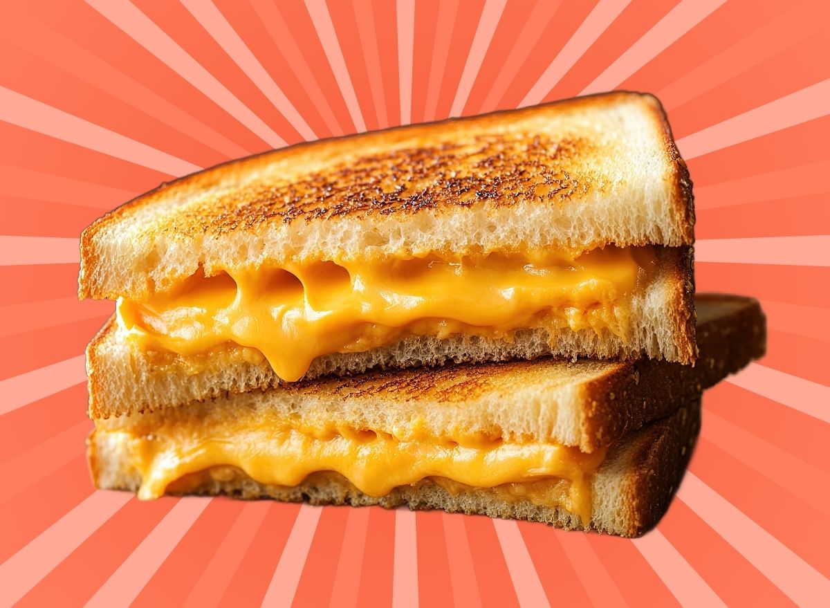 A melty grilled cheese sandwich set against a vibrant background.