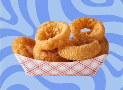 A carton of fried onion rings set against a vibrant background.