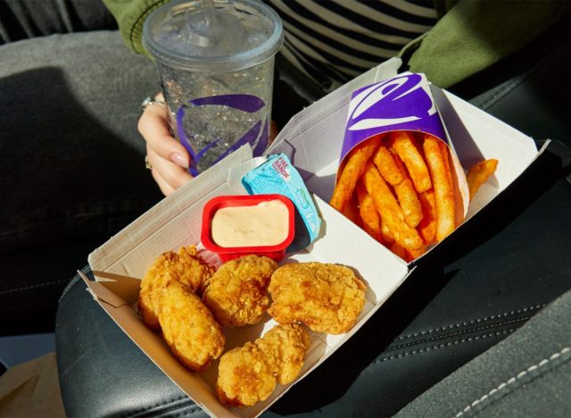 Taco Bell Crispy Chicken Nuggets, Nacho Fries, and Hidden Valley Ranch Fire Sauce inside car