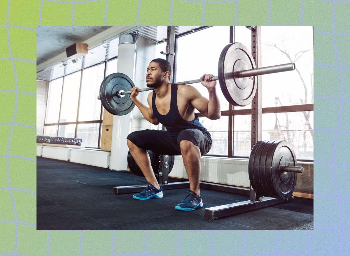 fit, muscular man doing barbell back squat exercise