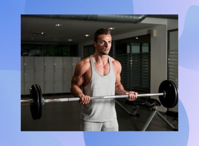 muscular man doing barbell curl in dark gym setting