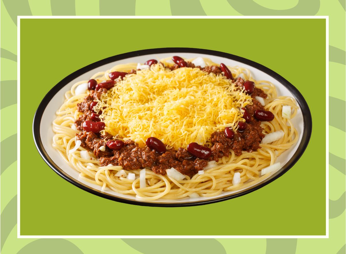 A plate of Cincinatti chili on a designed green background