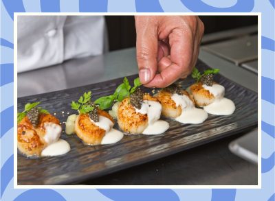 a photo of a chef plating scallops on a designed background