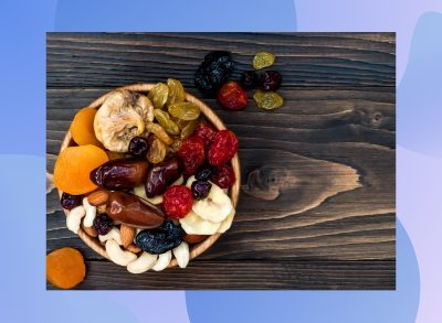 close-up of bowl of dried fruit and nuts on wooden table