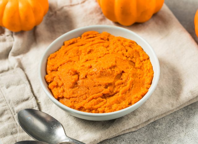 Organic raw orange canned pumpkin puree in a bowl