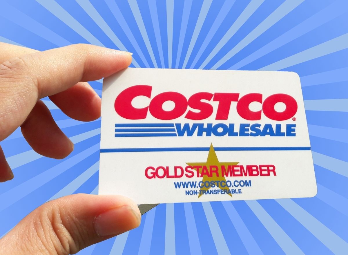 A closeup of a Costco Gold-level membership card set against a vibrant background.