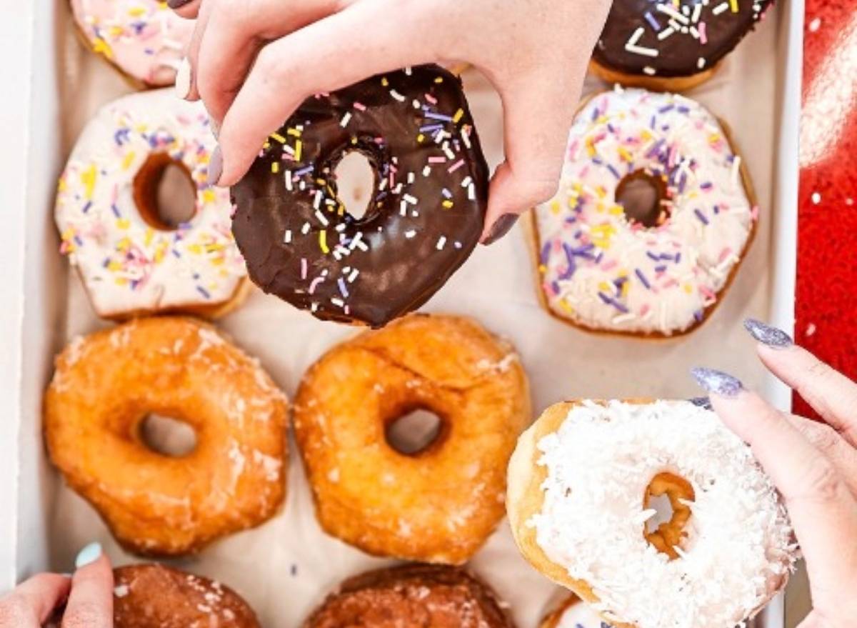 hands taking shipley donuts out of a box