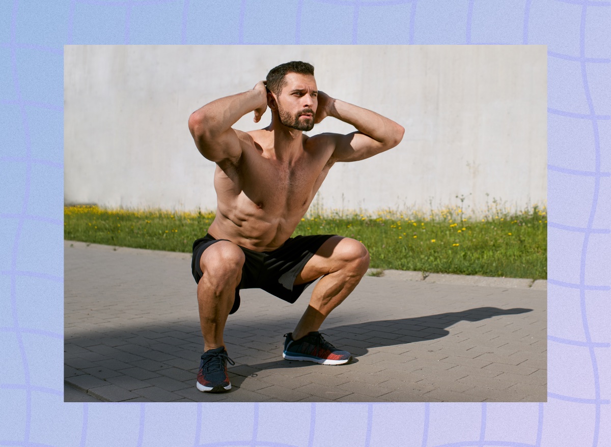 fit, muscular man doing bodyweight squats outdoors