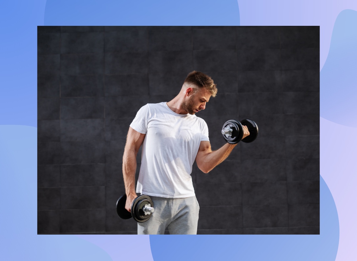 fit man lifting dumbbells in front of black backdrop