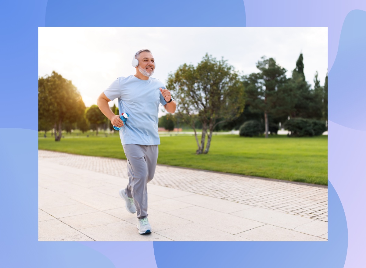 mature man running outdoors on paved trail in park