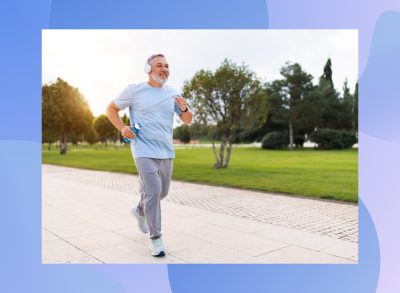 mature man running outdoors on paved trail in park