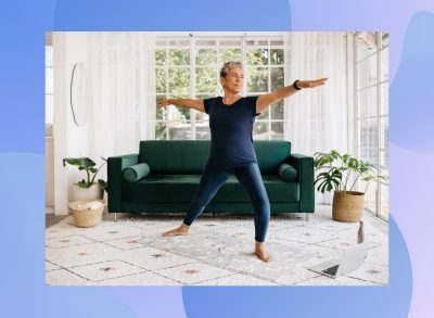 fit, mature woman doing yoga exercise in bright living space