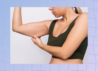 woman holding a bit of arm flab, concept of muscle loss