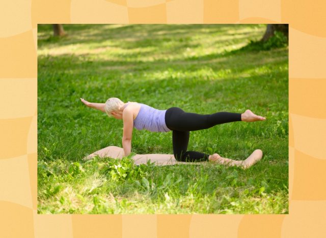 woman doing bird dog exercise on yoga mat in grassy area on summer day